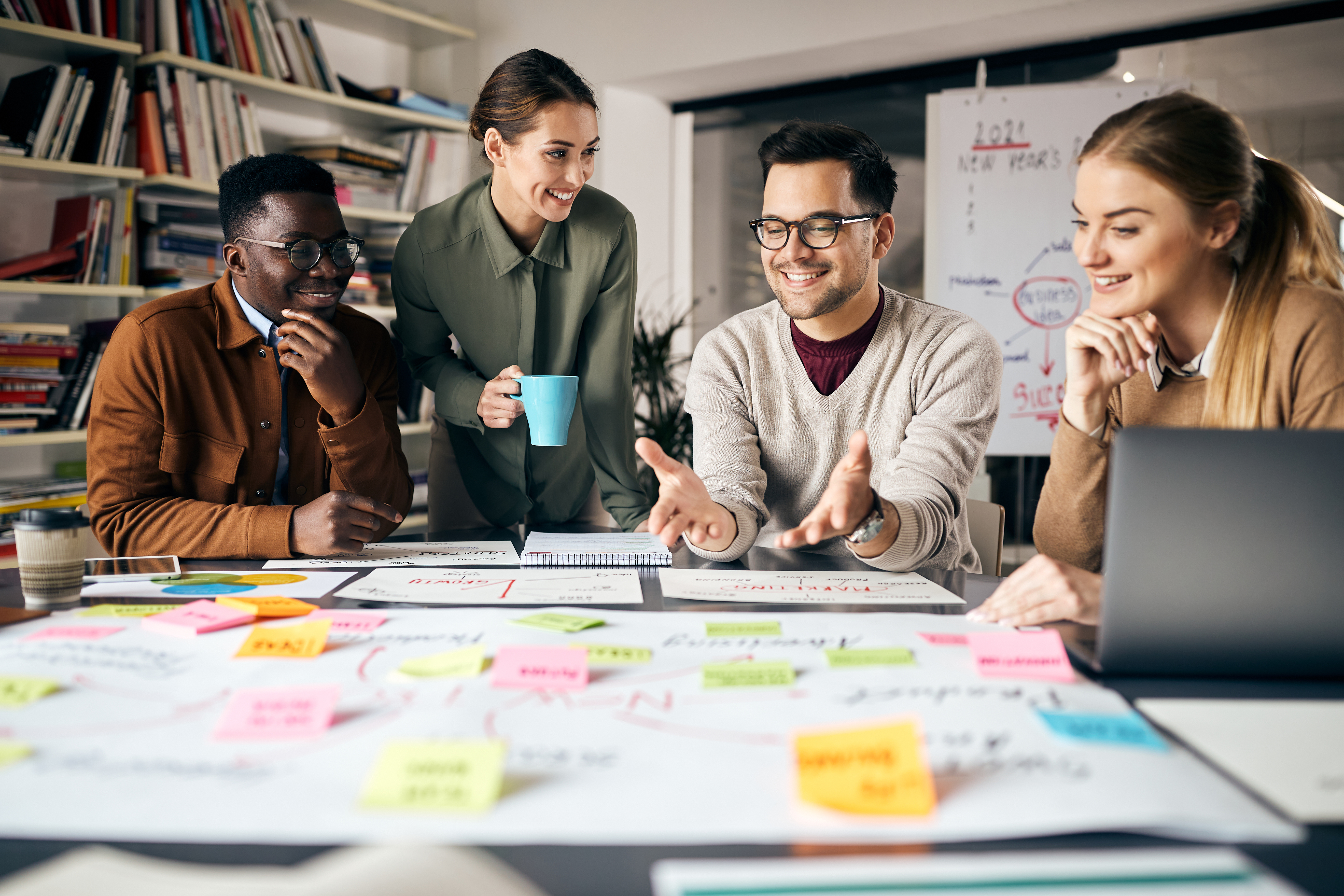 Featured image: Young happy startup team collaborating and discussing an inclusive attendance policy using a mind map during a business meeting in the office - Read full post: How To Write An Inclusive Attendance Policy